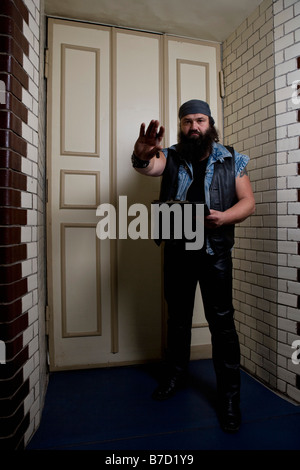 A bouncer in front of a door Stock Photo