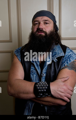 A bouncer standing in front of a door Stock Photo