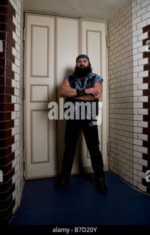 A bouncer standing in front of a door Stock Photo