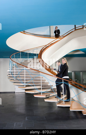 Business people walking up a staircase Stock Photo