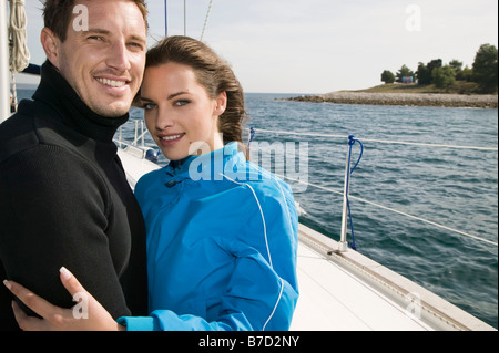 A couple embracing on a yacht Stock Photo