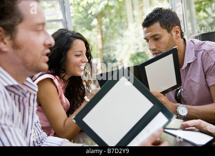 Men and women talking over menus Stock Photo