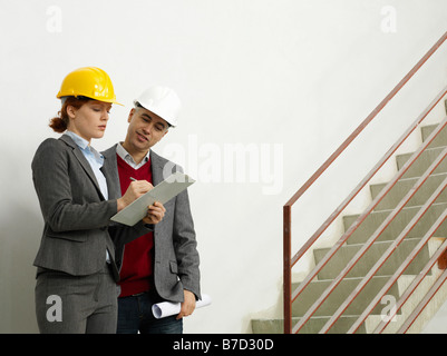 Two architects working on a construction site Stock Photo