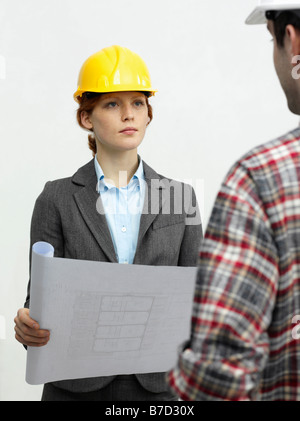 An architect speaking with a construction worker Stock Photo