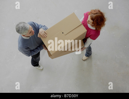 A couple carrying boxes together Stock Photo