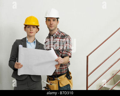 An architect speaking with a construction worker Stock Photo