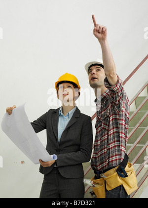 An architect speaking with a construction worker Stock Photo