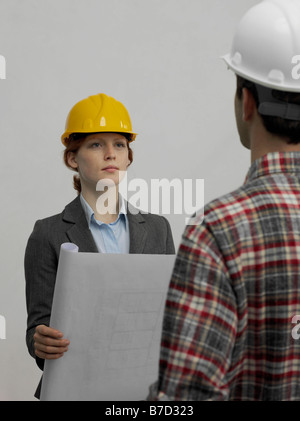 An architect speaking with a construction worker Stock Photo