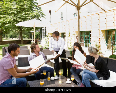 Men and women talking over menus Stock Photo