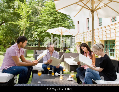 Men and women talking over menus Stock Photo