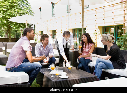 Men and women talking over drinks Stock Photo