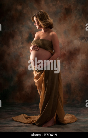Pregnant woman standing studio portrait Stock Photo