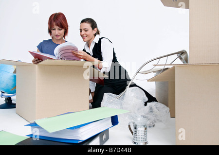 Business colleagues unpack office boxes Stock Photo