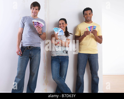 Group of friends choosing paint colours Stock Photo