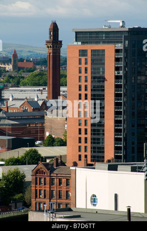High level view of an apartment block with the tower of Strangeways Prison in the distance, Manchester, England, UK Stock Photo