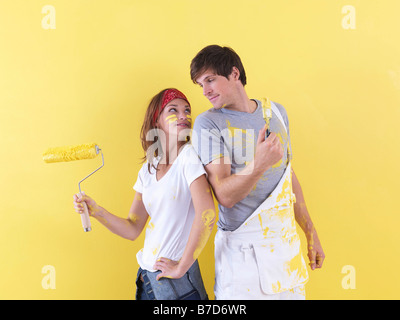 Couple posing in front of wall. Stock Photo