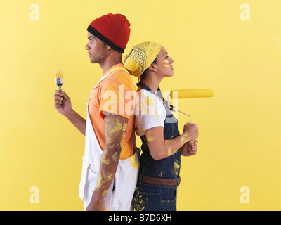 Couple posing in front of wall. Stock Photo