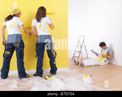 Girls painting man takes break. Stock Photo