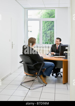 Co-workers at desk in office Stock Photo