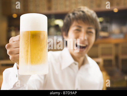 Man Holding a Stein of Beer Stock Photo