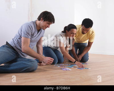 Group of friends choosing paint colours Stock Photo