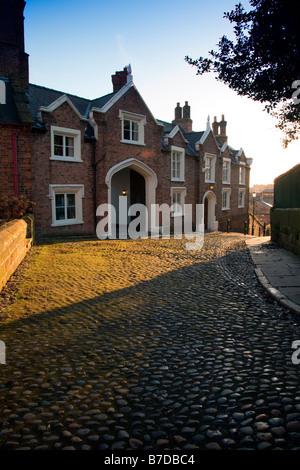 The old rectory at St Marys Hill in Chester as the sun begins to light the cobbled road in front of the building, Chester, England Stock Photo