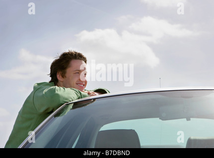 Man leaning on car Stock Photo