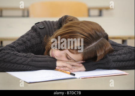 schoolgirl sleeping in class Stock Photo