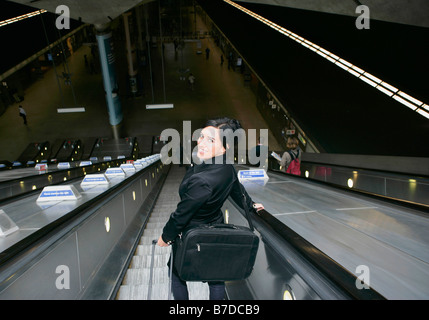 Woman on escalator Stock Photo