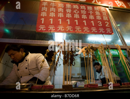 Traditional snacks for sale at night food market stall on Wangfujing street in Beijing 2009 Stock Photo