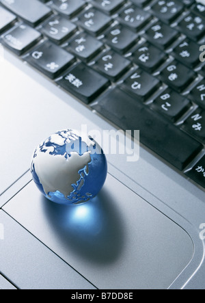 Keyboard and glass globe paperweight Stock Photo