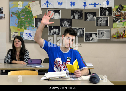 schoolboy raising his hand in class Stock Photo
