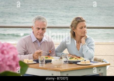 Couple dining at seaside restaurant Stock Photo