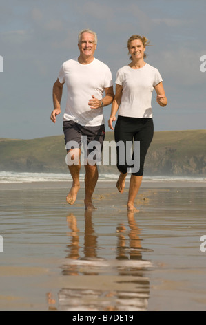 Couple running on a beach Stock Photo