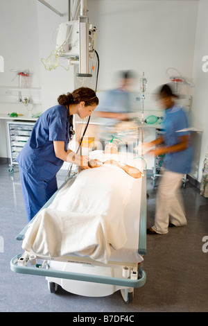 Nurse tending to patient in hospital bed wearing oxygen mask Stock ...