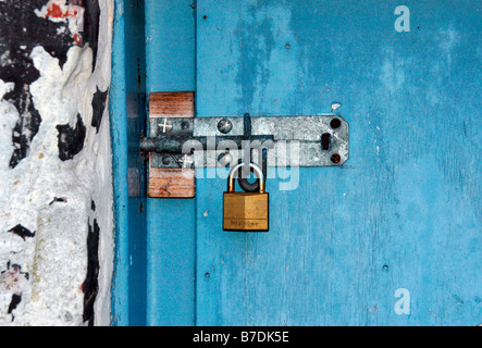 a bolted and padlocked old door. Stock Photo