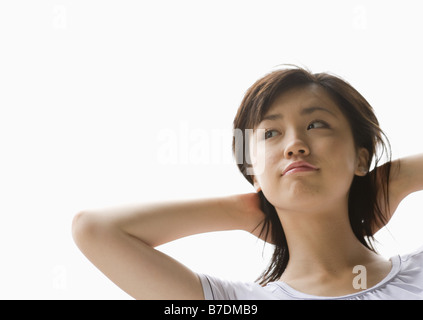 Nude woman putting her hands behind back Stock Photo - Alamy