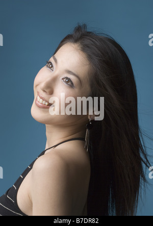 Woman looking over shoulder Stock Photo