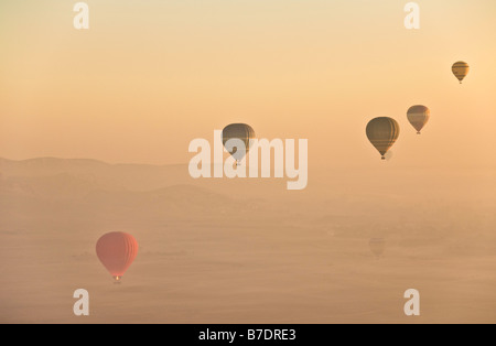 Lots of hot air balloons floating over the land west of the nile at Luxor at sunrise Egypt Middle East Stock Photo