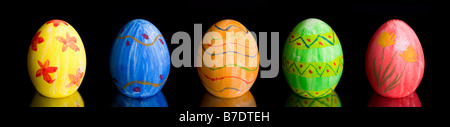 Row of five colorful Easter eggs over black background Stock Photo