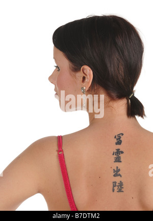 dark-haired woman with chinese tattoo on her back Stock Photo