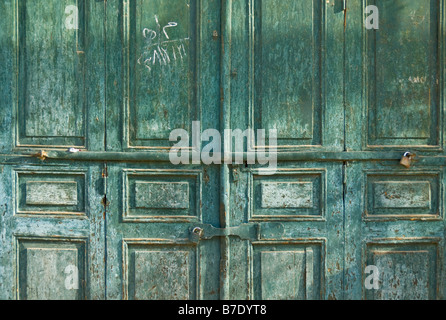 Old green painted wooden double doors in the souk in Aswan Egypt Middle East Stock Photo
