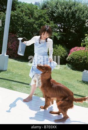 Woman playing with dog Stock Photo