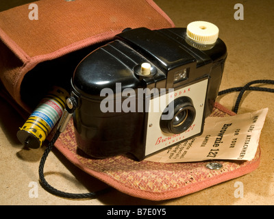 still life of Kodak Brownie 127 camera with case and a roll of colour film Stock Photo