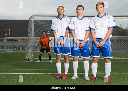 Footballers waiting for free kick Stock Photo