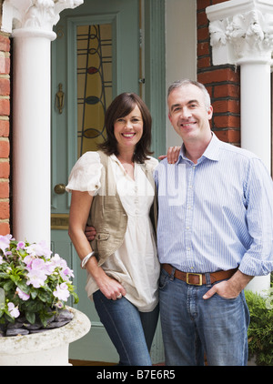 Portrait of man and woman at their front door Stock Photo