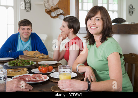 A family sat at a dining table Stock Photo