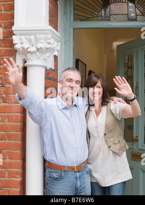 Mature man and woman waving Stock Photo