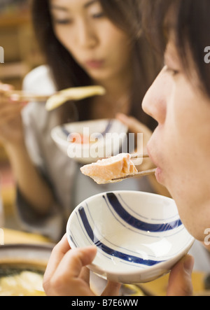 Couple Eating Japanese Style Chowder Stock Photo