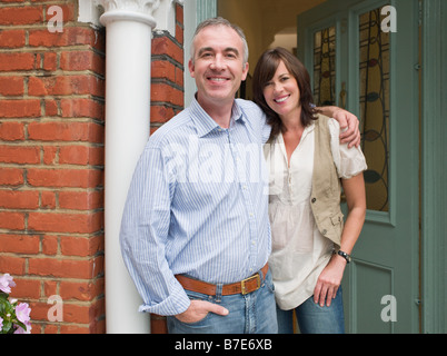 Portrait of man and woman at their front door Stock Photo